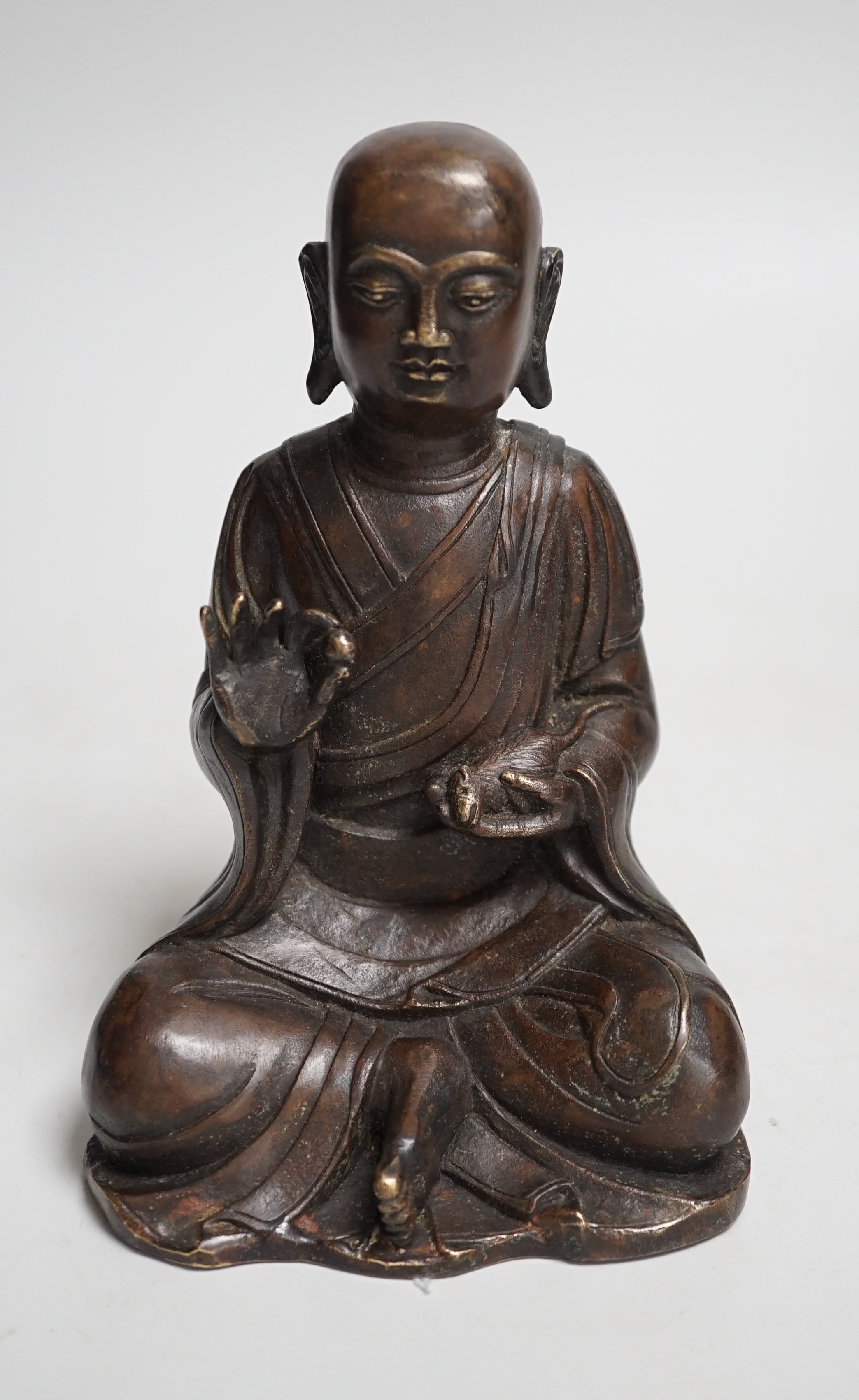 A Nepalese bronze figure of a seated immortal, probably 17th / 18th century, 16cm